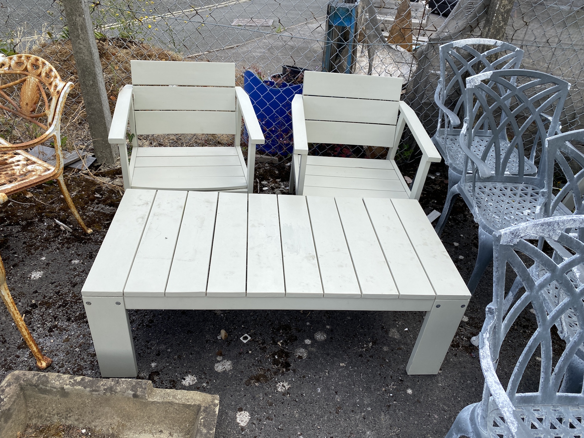 A Laura Ashley painted teak rectangular garden coffee table, length 124cm, depth 60cm, height 42cm and two elbow chairs